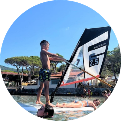 Bambini imparano il windsurf davanti al Camping Stella Mare a Lacona, Isola d’Elba